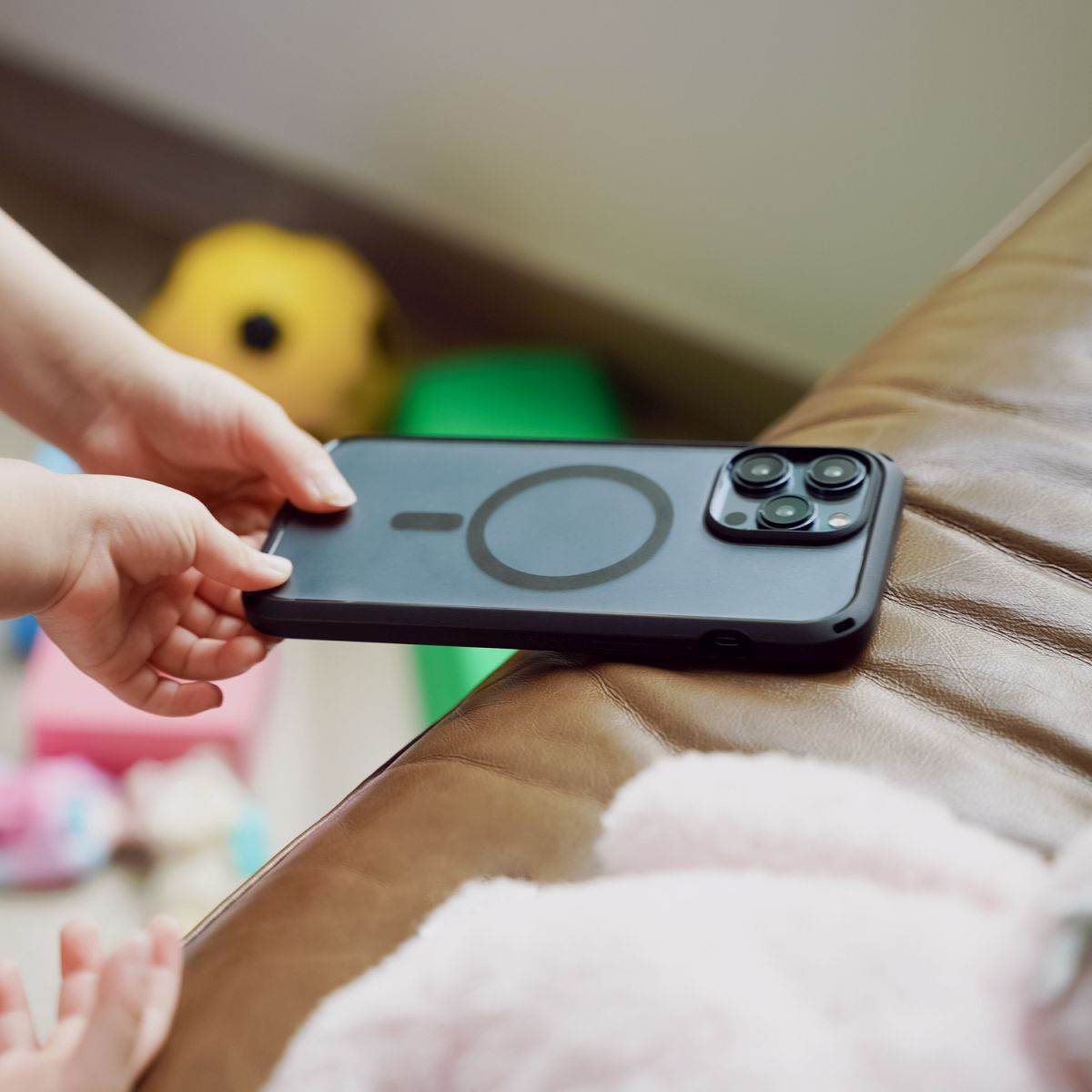 Catalyst-iPhone-15-pro-max-protective-stylish-drop-proof-iphone-cases-child-grabbing-phone-from-sofa.jpg