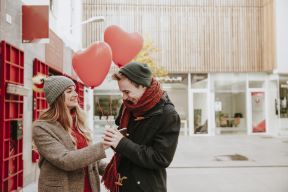 woman-giving-heart-balloons-smiling-boyfriend.jpg