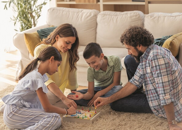stock-photo-family-gathered-in-cozy-living-room-plays-board-game-together-filled-with-laughter-and-smiles-2710669295.jpg