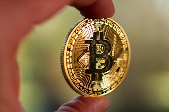 fingers-holding-bitcoin-wo(1).jpg