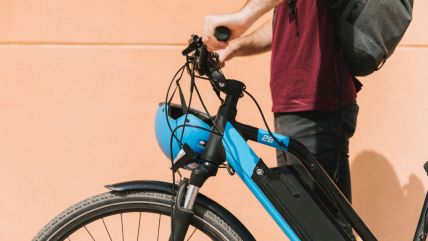 sideways-cyclist-standing-e-bike