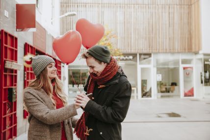 woman-giving-heart-balloons-smiling-boyfriend.jpg