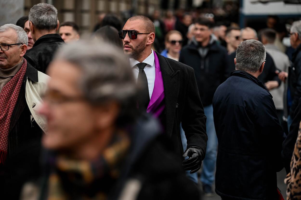 Stylish muškarac u ljubičastom odijelu na špici